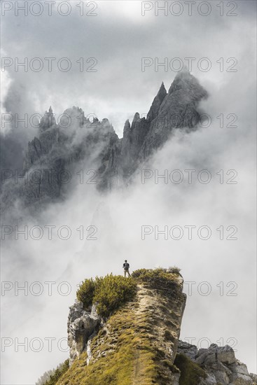 Mountaineer stands on a ridge