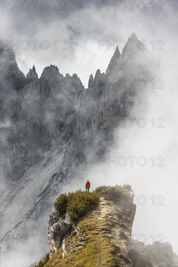 Mountaineer stands on a ridge