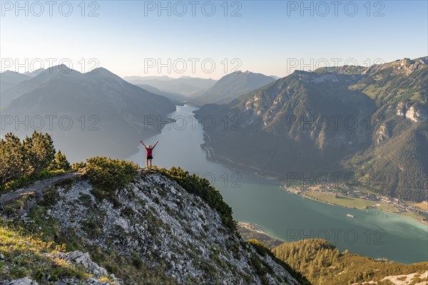 Young woman stretches arms in the air