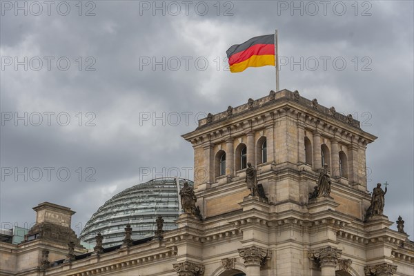 Reichstag with waving German flag at the Spree