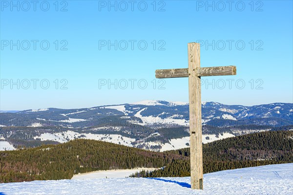 Summit cross of the Belchen in winter with snow