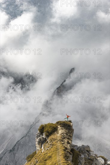 Mountaineer stands on a ridge