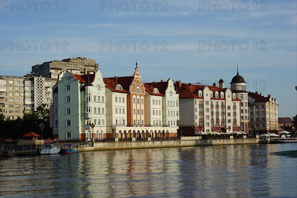 Row of houses in the quarter Fischdorf with historical lighthouse at the river Pregel