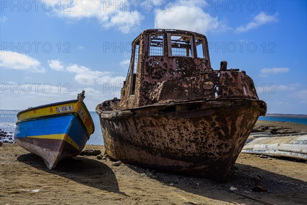 Old rusty boat on the beach at Pedra Lume