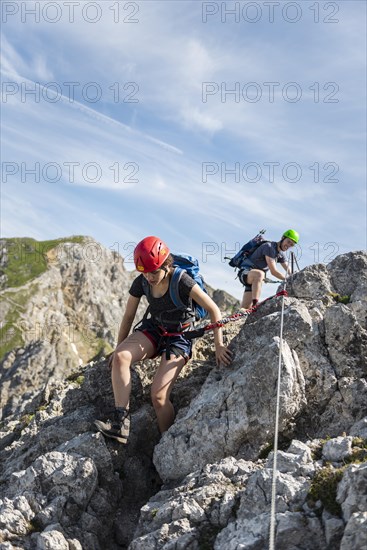 Mountaineer on a secured fixed rope route