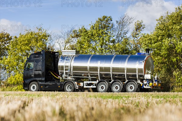 Truck with silo trailer on a dirt road
