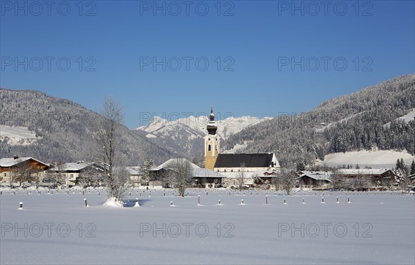 Village with parish church in winter