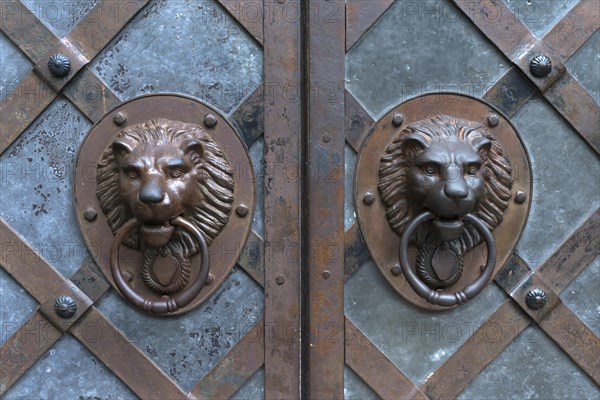 Lion heads as door knockers at the entrance gate of Rabenstein Castle