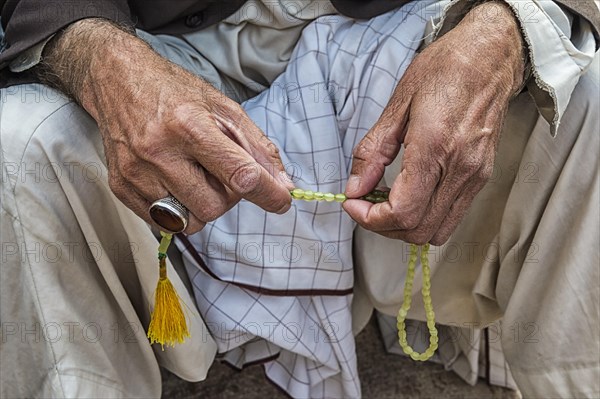 Muslim man with his sabha in Mozaffari Jame Mosque or Friday Mosque