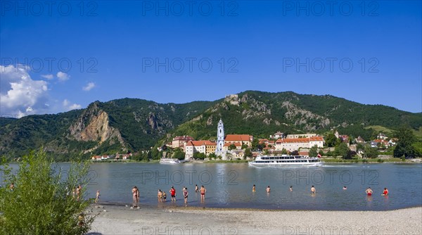 Bathing beach on the Danube with view of Duernstein Abbey