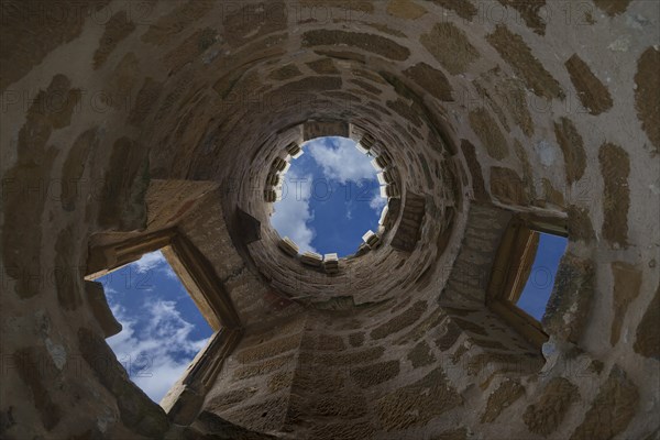 Round tower with bat boxes at the top of the rim