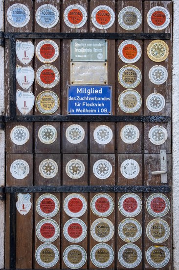 Barn door with many plaques