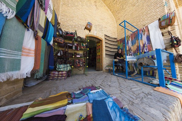 Iranian woman weaving a carpet