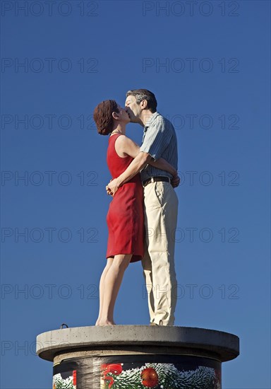 Sculpture Pillar saints couple II on an advertising pillar