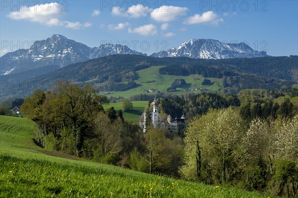 Former monastery Hoeglwoerth in front of the Berchtesgaden Alps