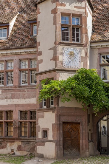 Historical house with sundial with inscription Carpe Diem