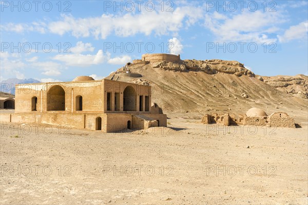 Ruins of ritual buildings in front of Dakhmeh Zoroastrian Tower of Silence