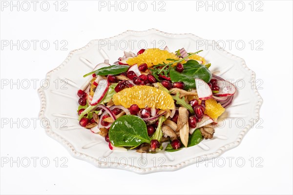 Served salad on a porcelain plate with orange slices