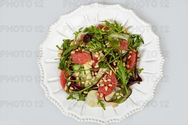 Served salad on a porcelain plate with grapefruit