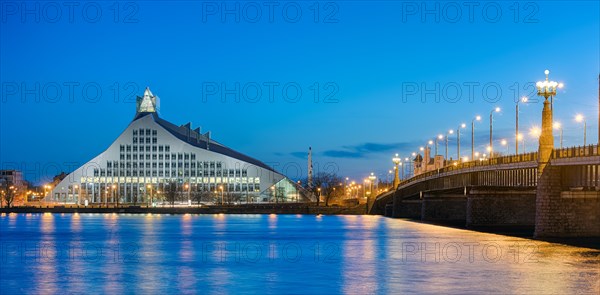 Bridge over Duena River with National Library at dusk
