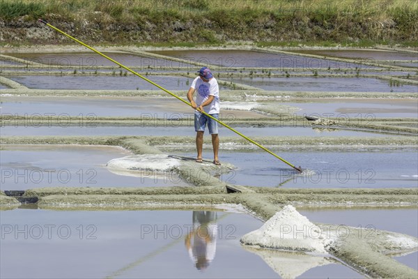 Man skimming salt