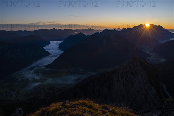 Sunrise over Lechtal Alps with fog in the valley