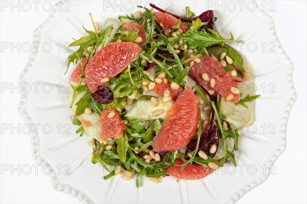 Served salad on a porcelain plate with grapefruit