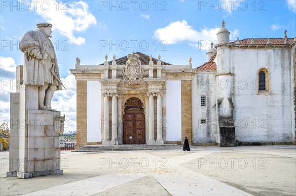 A student in traditional cloth walking through University of Coimbra