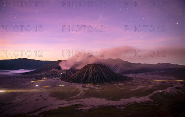 Volcanic landscape at sunrise with starry sky