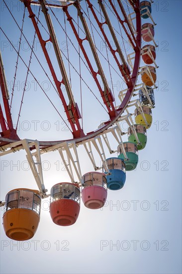 Colorful gondolas in front of a blue sky