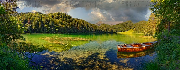 Idyllic Lake Alatsee with rowing boat