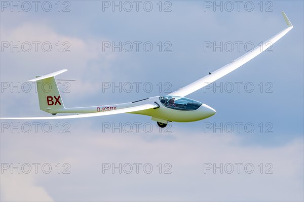 Glider flying in a cloudy sky