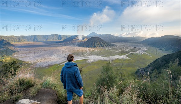Young man in front of volcanic landscape