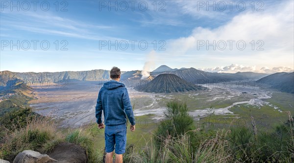 Young man in front of volcanic landscape