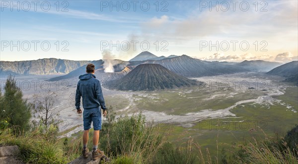 Young man in front of volcanic landscape