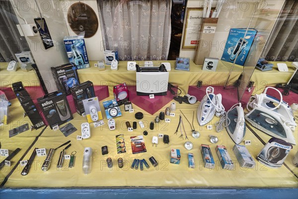 Shop window of an electrical corner shop with curtains in the Tuerkenstrasse