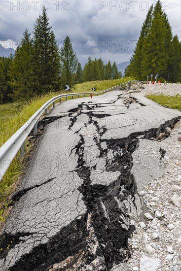 Broken road with cracks in the road surface