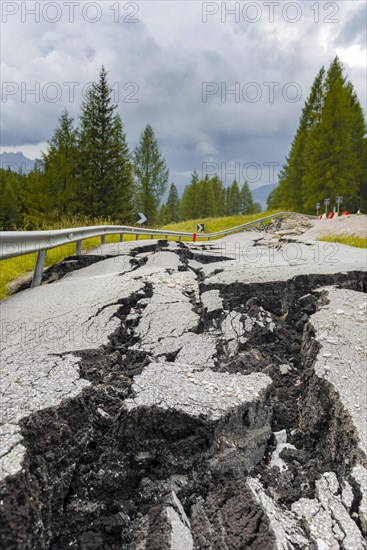 Broken road with cracks in the road surface