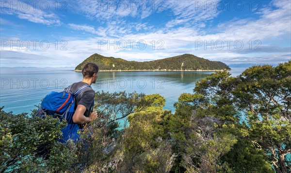 Walker overlooks Bay Astrolabe Roadstead with Adele Island