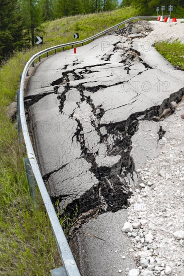 Broken road with cracks in the road surface