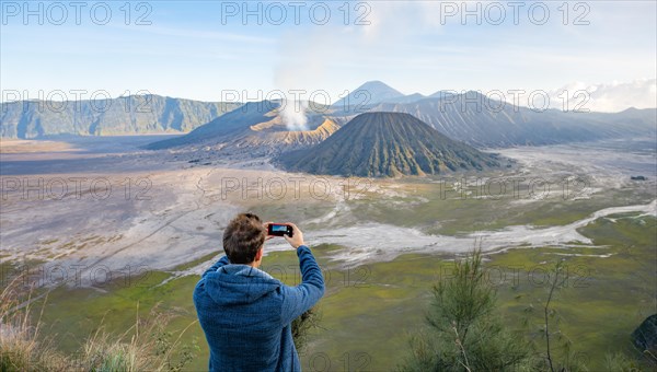 Young man takes photo with iPhone