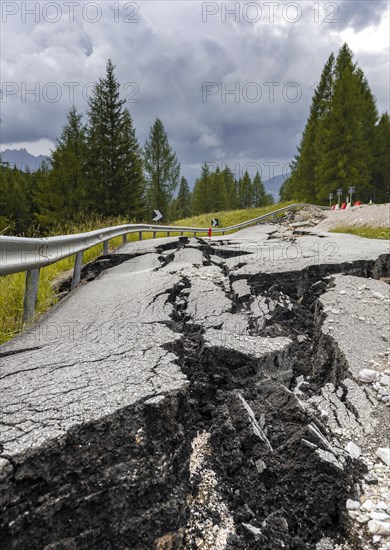 Broken road with cracks in the road surface