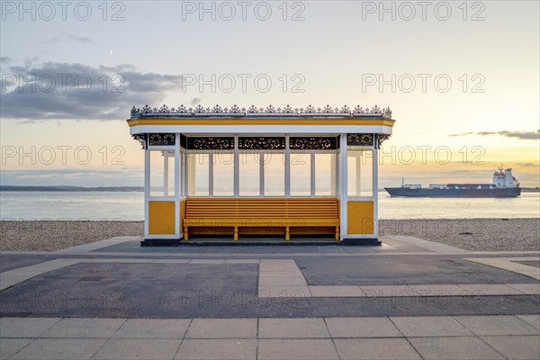 Yellow vintage bus stop by the sea in Portsmouth