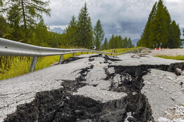 Broken road with cracks in the road surface