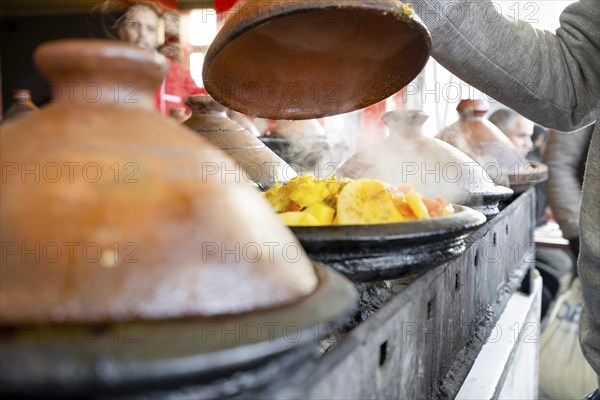 Delicious moroccan tajine prepared and served in clay pots