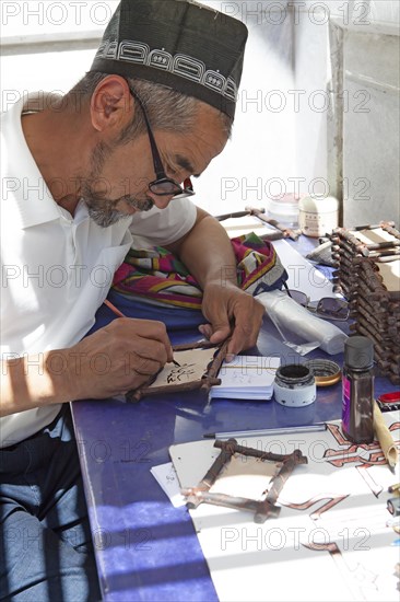 Writer writes in ancient oriental languages on leather