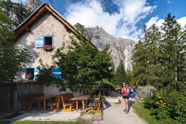 Hiker in front of a mountain hut