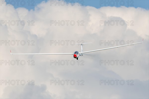 Glider flying in a cloudy sky