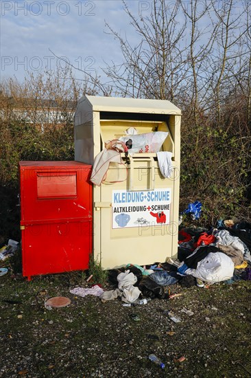 Overfilled old clothes container for clothes and shoes