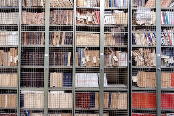 Locked bookshelves with plenty of old books